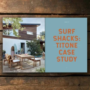 Surf magazine shown with surf board photography on one page, large colorful text on the other.