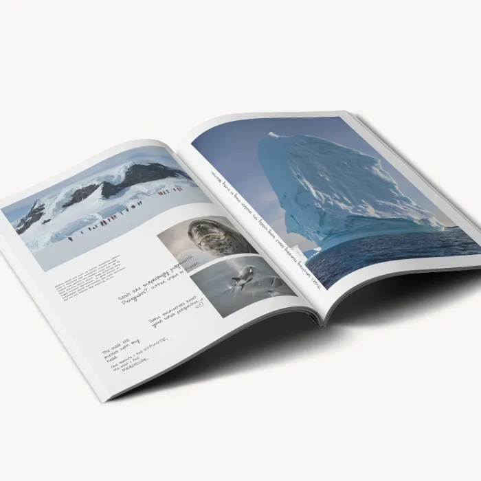 Open magazine spread displaying travel photography with glacier and wildlife imagery.