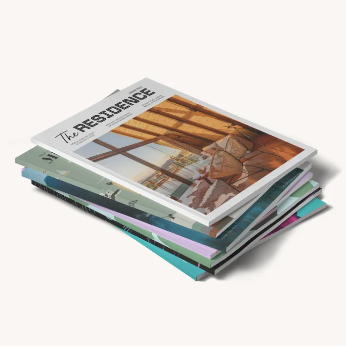 Stack of colorful magazines with interior design and architectural photography on the covers.