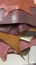 This close-up exploration reveals a stunning variety of leather hides, showcasing their unique textures, rich colors, and natural imperfections. A hand gently touches and lifts the material, demonstrating its softness and quality, perfect for crafts, fashion, or home decor. by @saudi.mentailor with saudi.mentailor by Original Sound