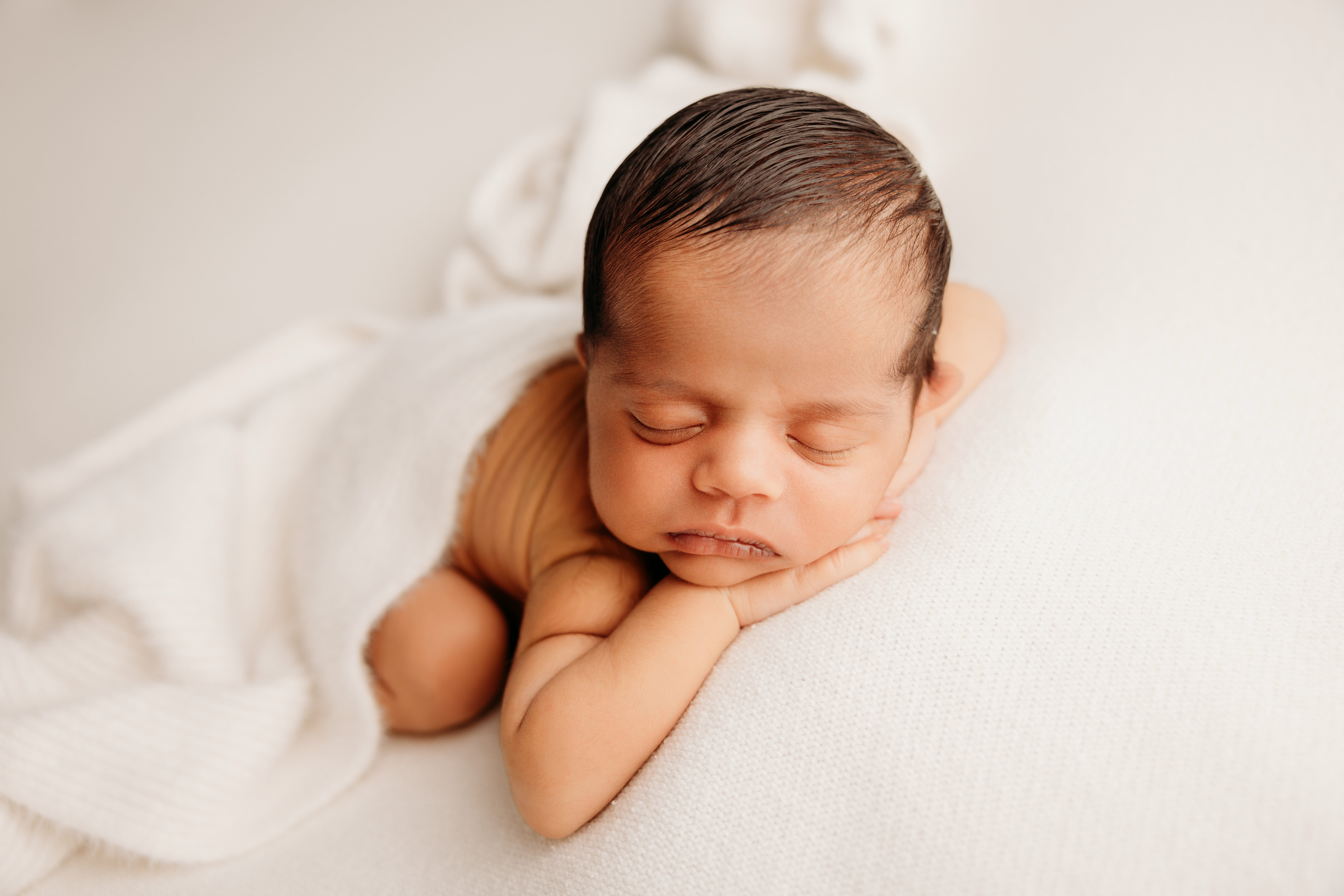 Auckland baby photographer. Taj in studio on a cream backdrop