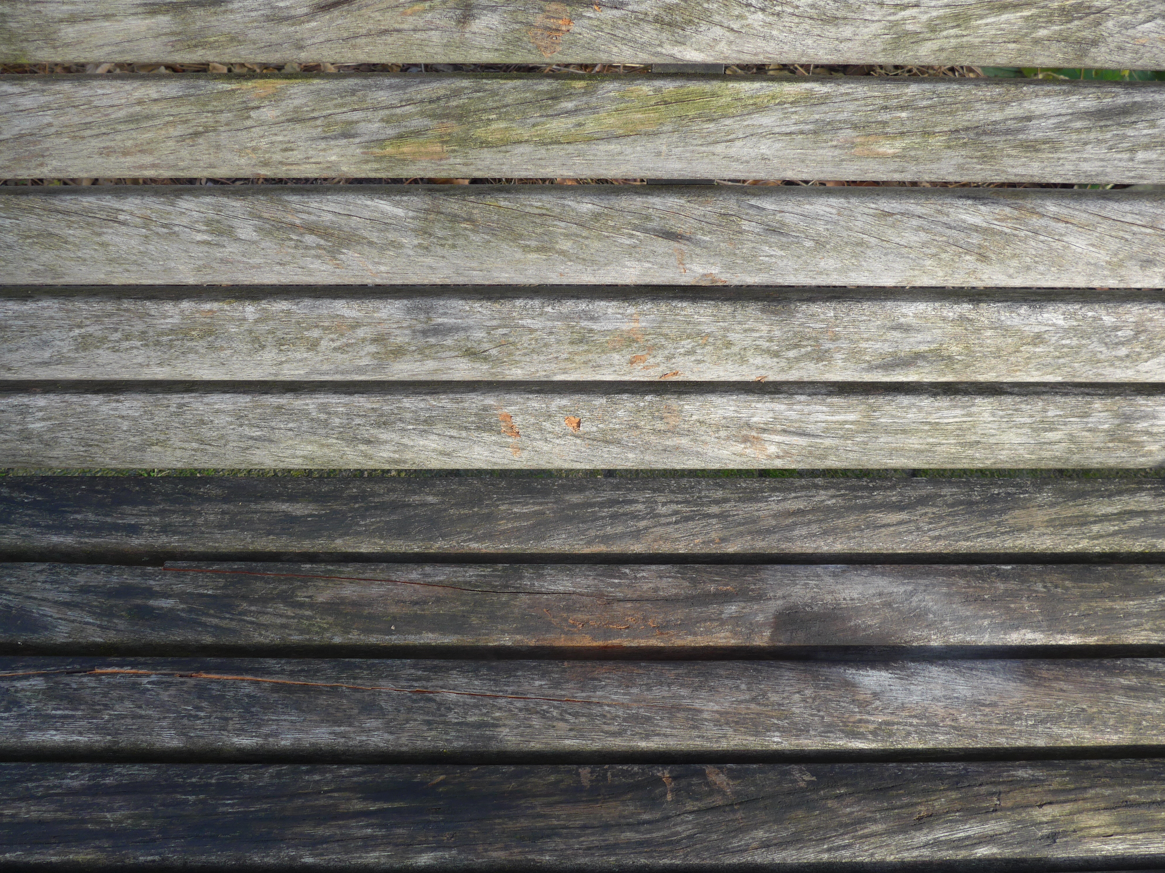 Close-up of a wooden bench with weathered planks