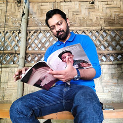 Tahsn Khan with magazine.jpg