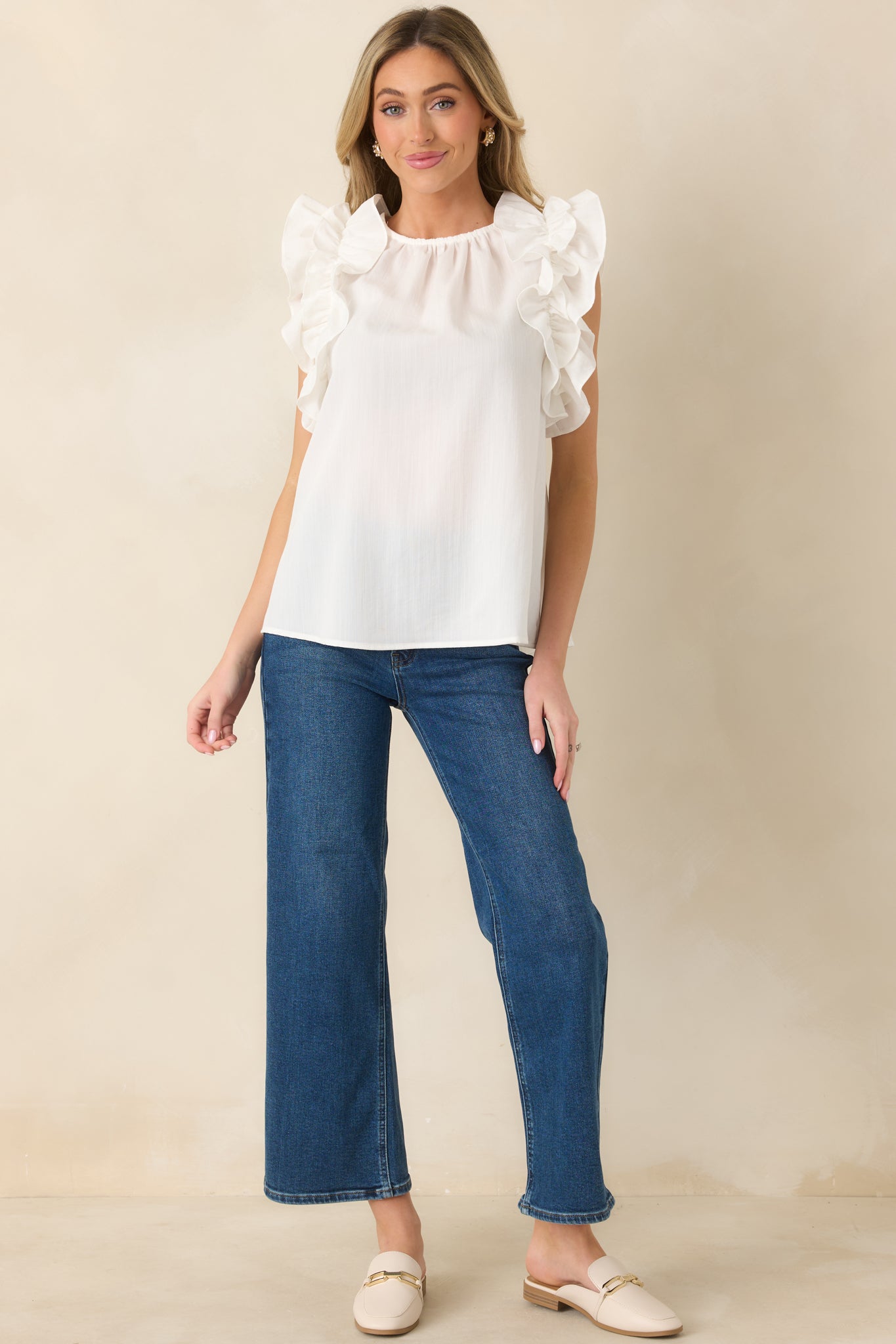 Straight-on view of dark wash jeans highlighting high-rise fit, belt loops, and cropped hem.