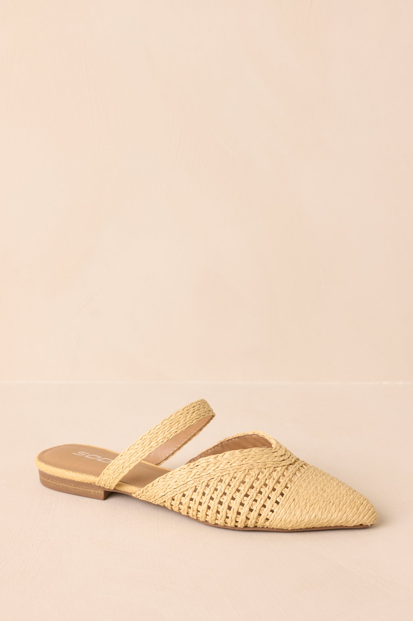 Side cropped view highlighting the slip-on mule structure and flat sole.