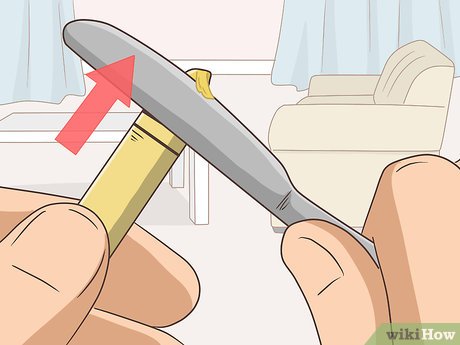 Step 2 Glide the knife on the tip of the crayon, going back and forth.